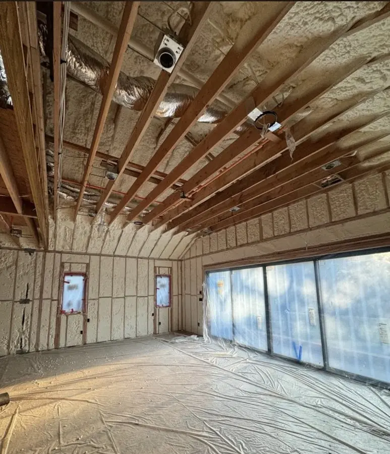 Interior walls and ceiling insulated with spray foam during new construction in Sturbridge